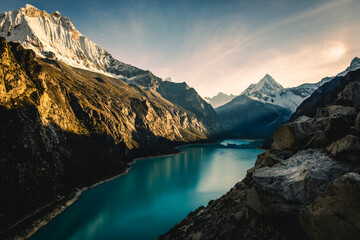 epic sunrise at Laguna Paron Turquoise Water Peruvian Andes Lake Between Mountains and Pyramid...
