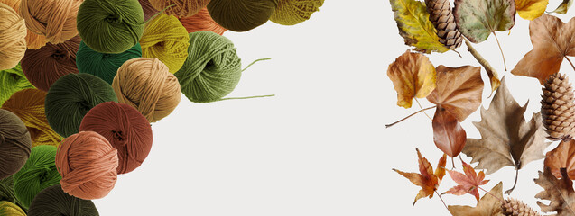 Balls of wool yarn for hand knitting and dry leaves on white background. Autumn mood. Mock up, flat lay, copy space, banner