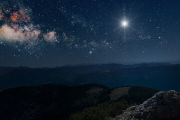 The star shines over the manger of christmas of Jesus Christ.