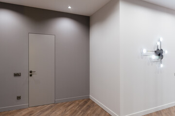 Fototapeta na wymiar bright and stylish interior design of a corridor with a dark and light wall