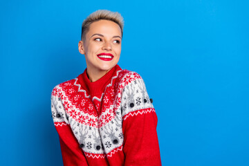 Portrait of smiling positive short blonde hair lady wear red ornament festive sweater look empty space invitation isolated on blue color background