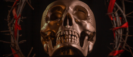 Skull of a person with crown of thorns close up on a black background