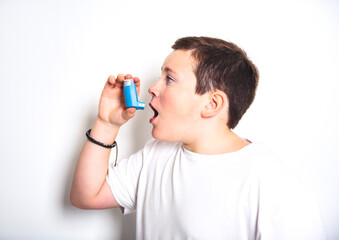 child using inhaler for asthma over White background studio