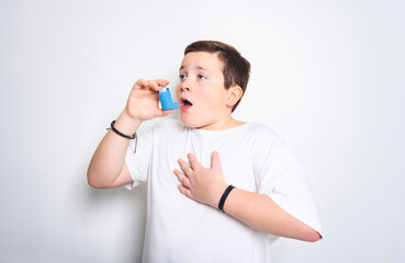 child using inhaler for asthma over White background studio