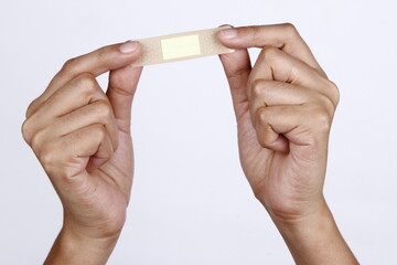 Band aid being held by a pair of hands
