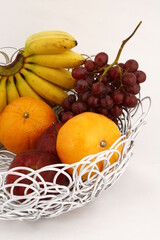Metal looping table basket with various fruits