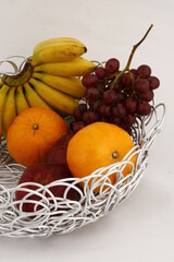 Metal looping table basket with various fruits