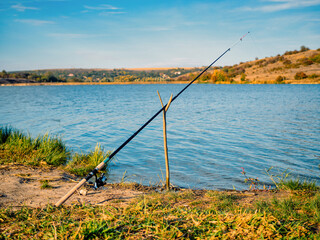 Fototapeta na wymiar Peace of mind and mindfulness. Fishing on the lake in autumn. Selective focus