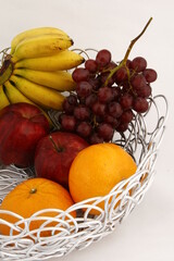 Metal looping table basket with various fruits