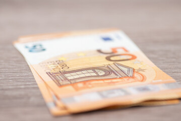 Two euro banknotes on wooden table. Close up shot of european money currency, 50 nominal