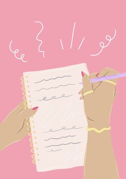 Hands writing in notebook