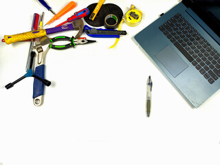 Flat lay, background mockup. The workspace on the desk background is white from the top view. layout room with laptop, handyman equipment and pencil on a white table background.