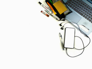 Flat lay,background mockup. the workspace in the background of the desk is white from the top view. layout space with mobile phones, laptop, books, pencils, stationery on a white desk background.
