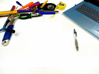 Flat lay, background mockup. The workspace on the desk background is white from the top view. layout room with laptop, handyman equipment and pencil on a white table background.