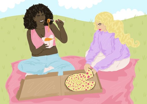 Two girls eating on a picnic