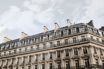 Fototapeta na wymiar Parisian apartments and cloudy sky on background