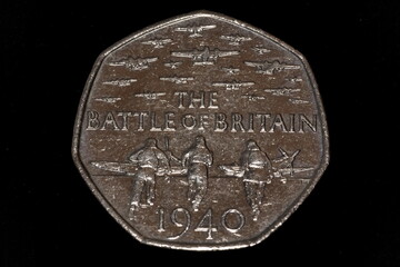 Closeup macro image of a circulated commemorative 2015 Battle of Britain 50p piece on a black background