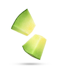 Slices of cantaloupe melon falling in the air isolated on white background.