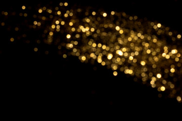 Golden blurred bokeh lights on black background. Glitter sparkle stars for celebrate. Overlay for your design