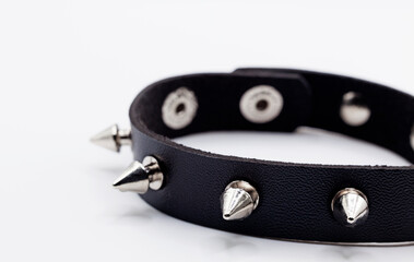 rivet bracelet with black leather on white background
