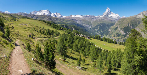 Fototapeta na wymiar The panorama of swiss walliser alps with the Matterhorn and Breithorn peaks over the Zermatt in Mattertal valley.