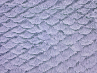 Closeup of purple faux fur with scallop pattern