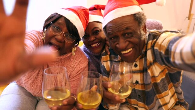 video call african american family grandparents with granddaughter taking selfie on christmas eve