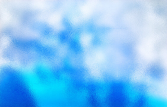 Frosted blue glass texture. Colorful lights background.
