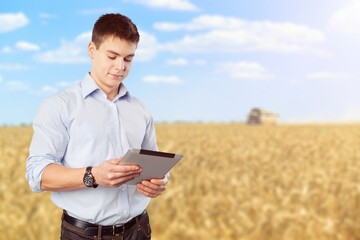 Agronomist male farmer with digital tablet at field