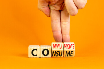 Consume or communicate symbol. Concept word Consume or Communicate on wooden cubes. Beautiful orange table orange background. Businessman hand. Business consume communicate concept. Copy space.