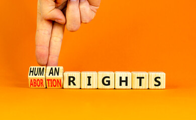 Abortion rights symbol. Concept words Abortion rights are human rights on wooden cubes. Businessman...
