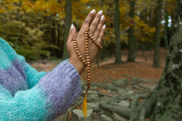 female hands holding the buddhist mala