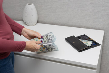 man counts cash dollars with his hands