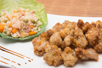 sesame chicken dish and chopsticks on bamboo placemat