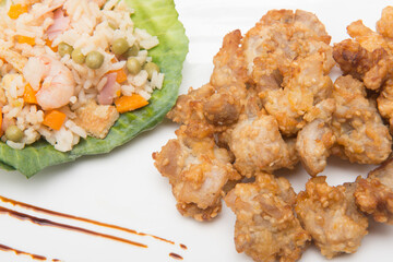 sesame chicken dish and chopsticks on bamboo placemat