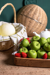 basket with green apples on the table