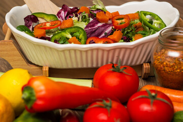 Healthy and fresh salad in bowl with vegetables and fruit