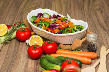 Healthy and fresh salad in bowl with vegetables and fruit