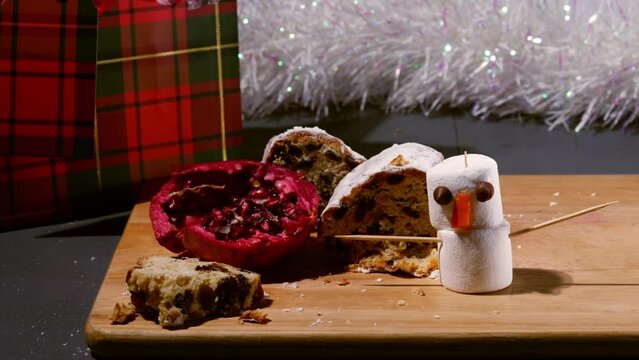 Christmas cake Stollen marshmallow snowman and pomegranate fruit 