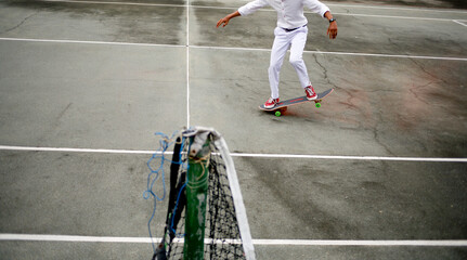 Asian student wear white uniform playing skateboard trick in the park. Copy space. Banner.