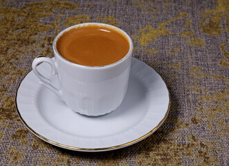 a cup of Turkish coffee on a table