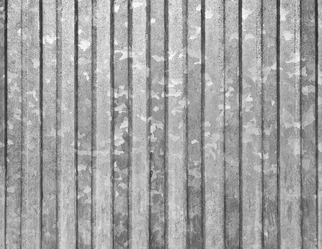Corrugated vertical sheet aluminum facade. Grunge grainy metal texture. Silver color industrial pattern. Garage construction gray striped wall.
