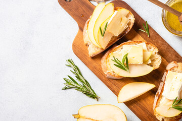 Sweet toast with pear, cheese and honey. Healthy snack or breakfast. Top view with copy space.