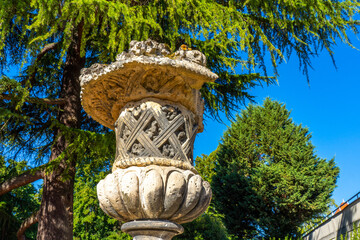 Beautiful old stone vase in the park. Old french architecture. High quality photo