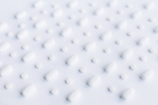 White pills on the white background © Olena Svechkova