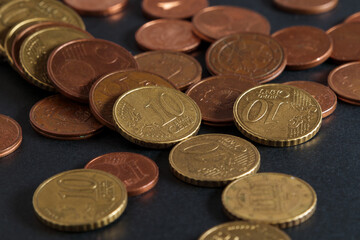 Euro coins close up. Small change, petty cash on a black table