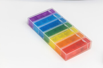 Tablets in a dispenser on a white background.