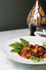 udon with mushrooms and chicken. noodles on a white plate