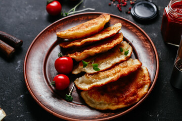 Chebureks with meat on a plate. Fried pies