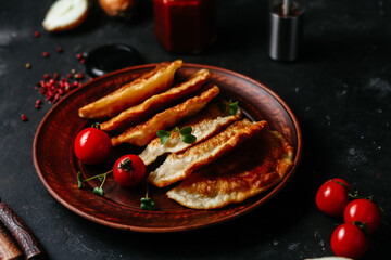 Chebureks with meat on a plate. Fried pies